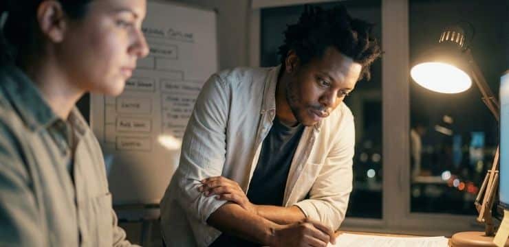 Build Your Dream Team Founder training new employee in small office while struggling to delegate control